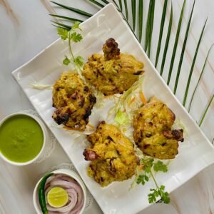 Overhead shot of flavorful Indian tandoori chicken with accompaniments, perfect for food lovers.