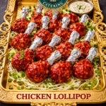 Food Forest Catering spicy chicken lollipop platter with foil wrapped drumettes in red sauce on gold tray