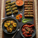 Food Forest Catering mixed kebab and starter platter with seekh kabab sesame bites chicken tikka and chilli chicken on slate board