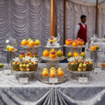 Food Forest Catering elegant dessert and fruit display on silver tiered stands with sorbet cups and pineapple tartare at banquet