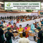 A bustling documentary-style photograph of a large outdoor community catering event in Mumbai managed by Food Forest Caterer. The image shows a very long, organized buffet line staffed by caterers in uniform green aprons serving hundreds of diverse guests. Behind them, rows of tables are filled with people happily eating. A large banner prominently features the "Food Forest Caterer" logo and details their specialization in feeding 500 to 5000+ guests. The scale is massive, illustrating a busy community gathering.