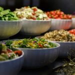 Fresh salad buffet spread with multiple bowls of colourful vegetables and mixed salads at catering event